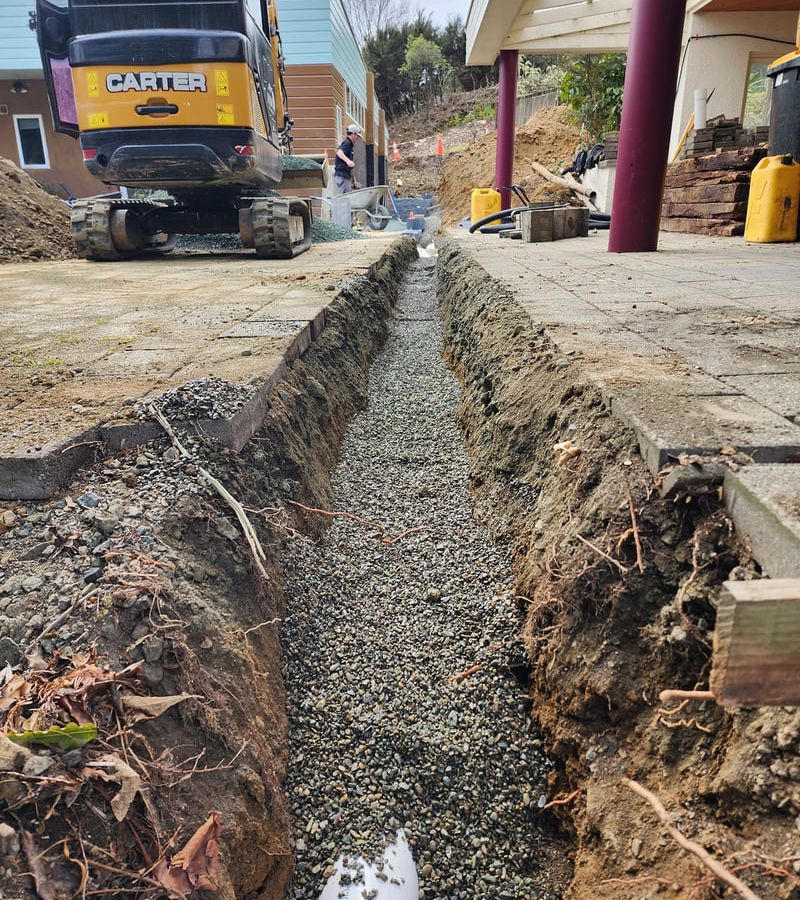 Professional drainage installation showing stormwater management system and pipe installation for property protection in Nelson Tasman