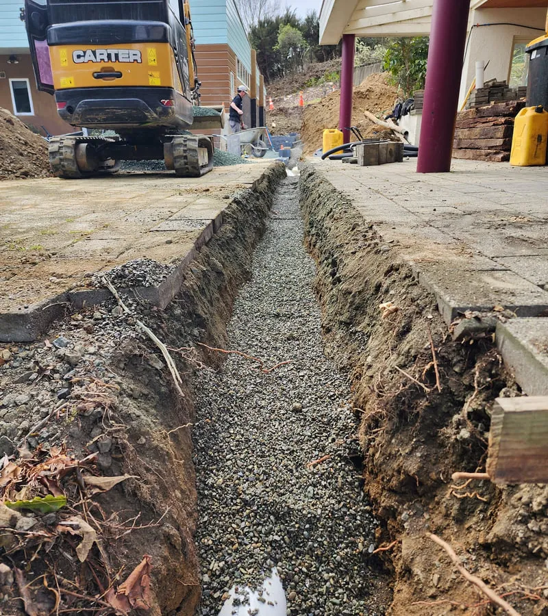 Professional drainage installation showing stormwater management system and pipe installation for property protection in Nelson Tasman