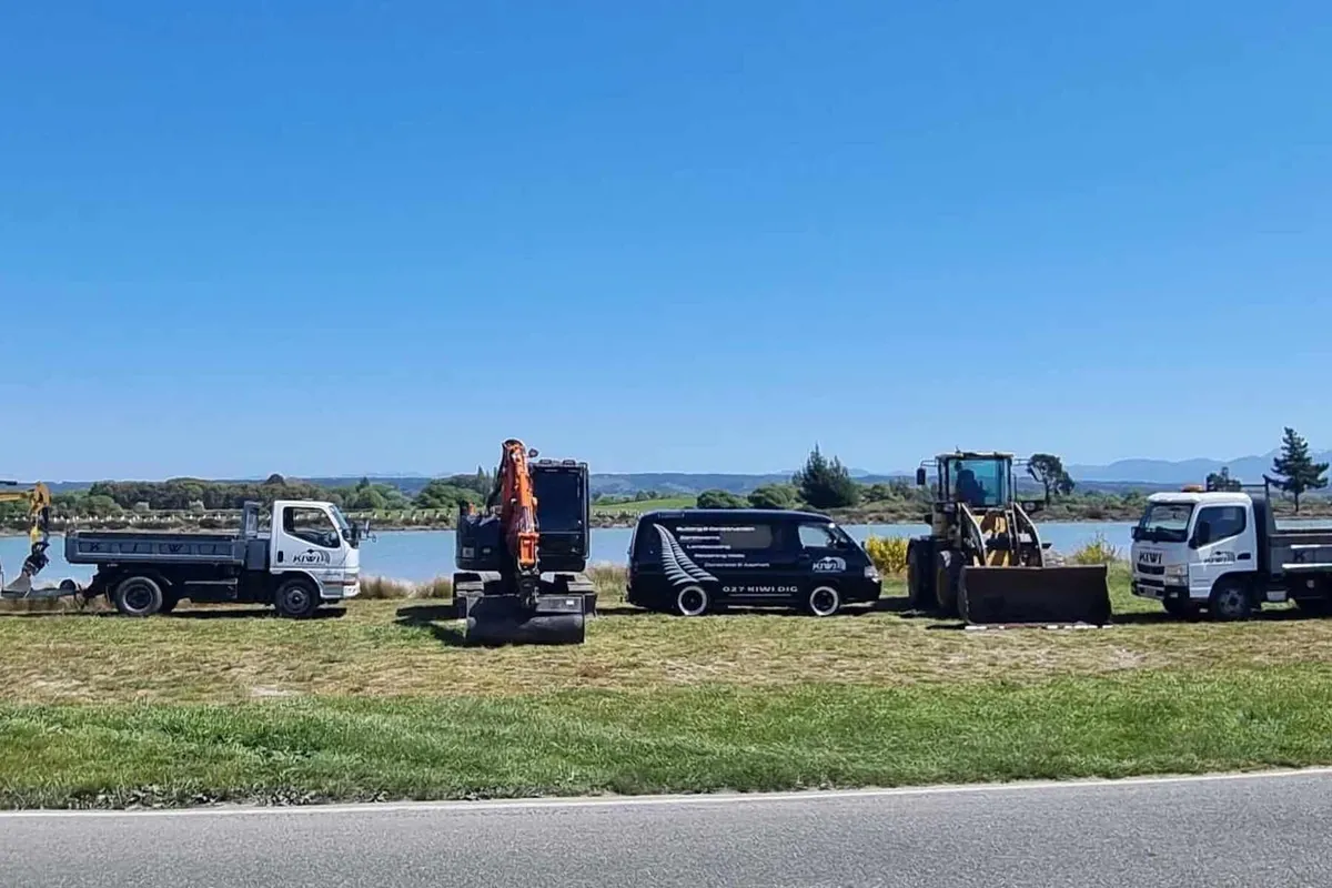 Fleet of modern excavators and earthmoving machinery lined up, showcasing Kiwi Excavations professional equipment for construction projects in Nelson Tasman