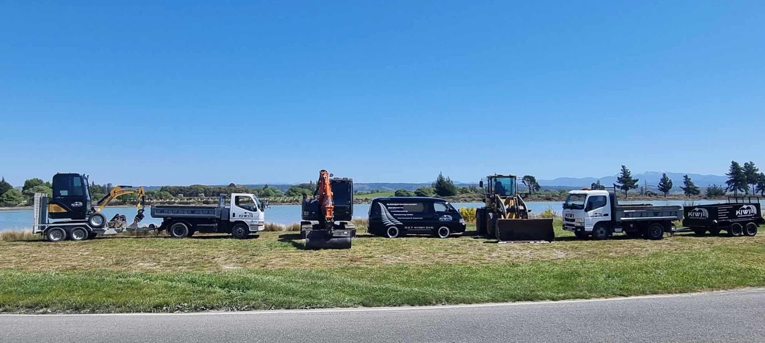 Fleet of modern excavators and earthmoving machinery lined up, showcasing Kiwi Excavations professional equipment for construction projects in Nelson Tasman