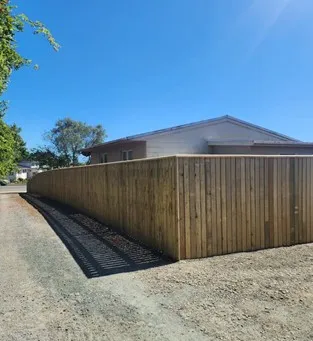Tall timber fence with spacing for airflow and modern aesthetic