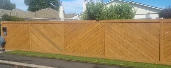 Timber fence with diagonal palings and picture frame